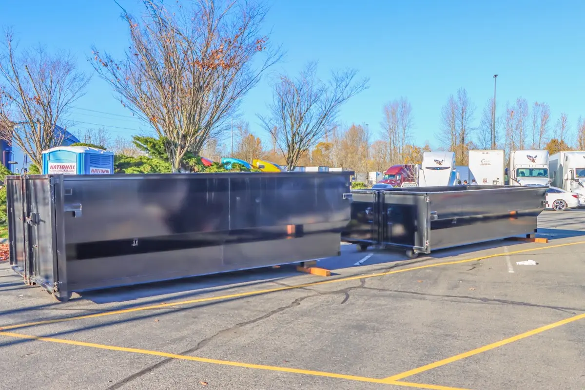 Professional dumpster rental service with roll-off container on residential driveway in Saks